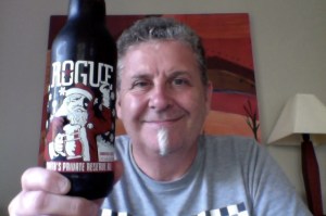 Man who needs a haircut holds a beer