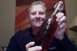 Man with a frown who needs haircut waves a beer