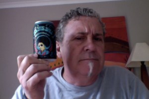 Man with Big almost Afro hair holds a small can