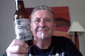 confused man holds Danish belgian ipa fruit beer